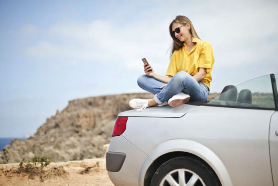 A girl sat on a rental car in Mojacar